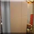 F37. White storage cabinet. 